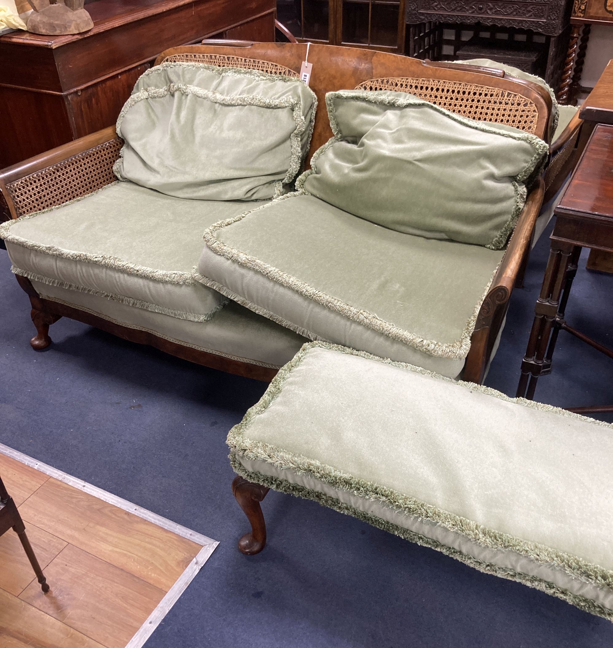 A 1920s mahogany framed three piece Bergere suite, together with a stool